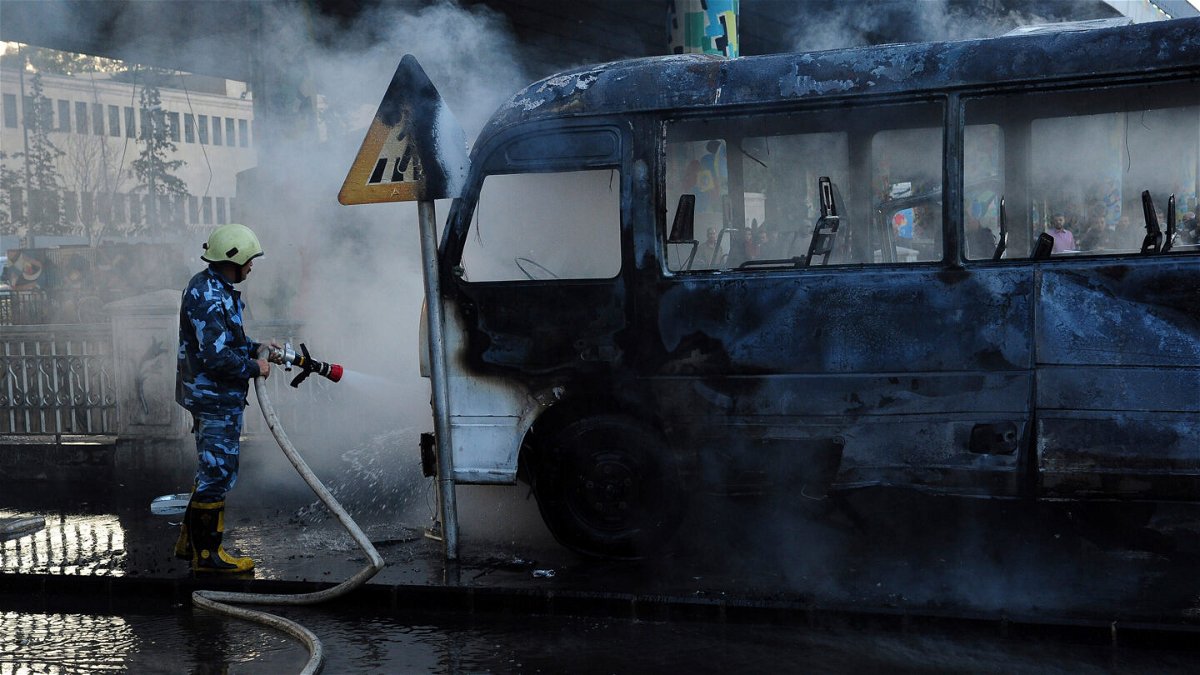<i>SANA via AP</i><br/>Four children were among at least 10 people killed in Syrian regime strikes in the northwestern rebel-held area of Idlib on October 20 a rescue group said. A firefighter is seen extinguishing a military bus.