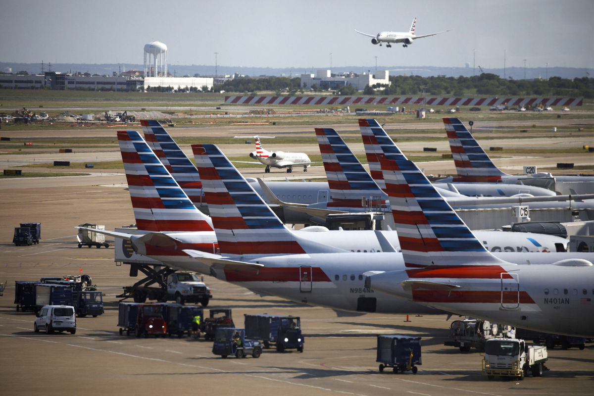 American Airlines planes parked at passenger gates at Dallas/Fort Worth International Airport (DFW).