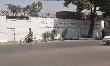 Taliban paint over mural in Kabul and replace it with text that reads "don't trust the propaganda of the enemy".