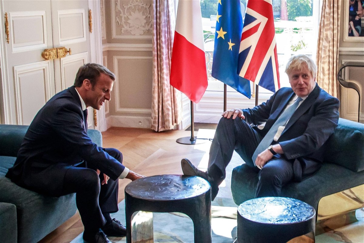 <i>CHRISTOPHE PETIT TESSON/AFP/Getty Images</i><br/>France has detained a British fishing vessel and announced it will close nearly all of its ports to trawlers from the UK. French President Emmanuel Macron and Britain's Prime Minister Boris Johnson are seen here in 2019.