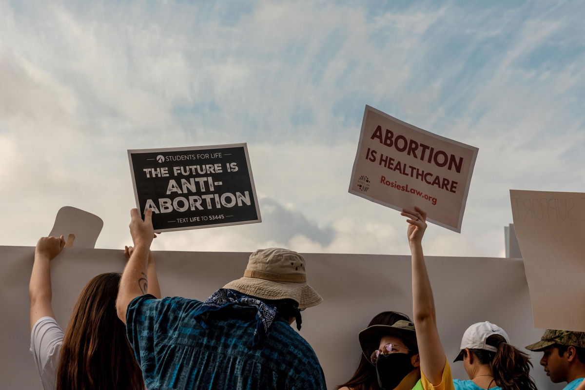 Demonstrators hold pro-life and pro-choice signs outside the Texas State Capitol in Austin, Texas.