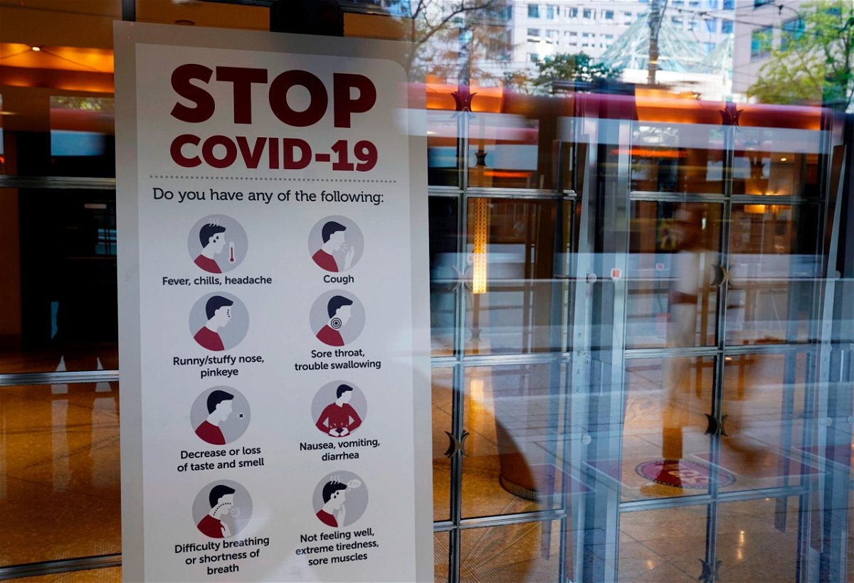 <i>Chris Pizzello/Invision/AP</i><br/>A sign reminds festivalgoers to monitor themselves for possible coronavirus symptoms in the entrance of the Princess of Wales Theatre on day one of the 2021 Toronto International Film Festival