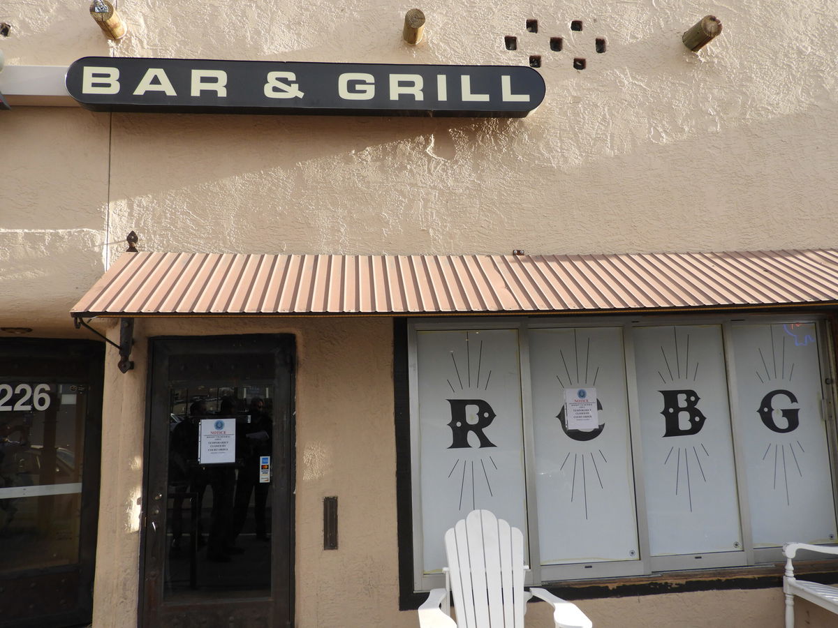 A closure order is posted in the window of Rockin' Cigar Bar in the Cincy District.