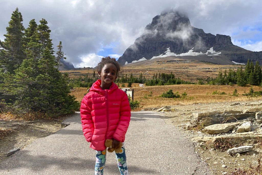 5-year-old Naomi Pascal, holding her teddy bear, is pictured on a hike to Hidden Lake in Glacier National Park.