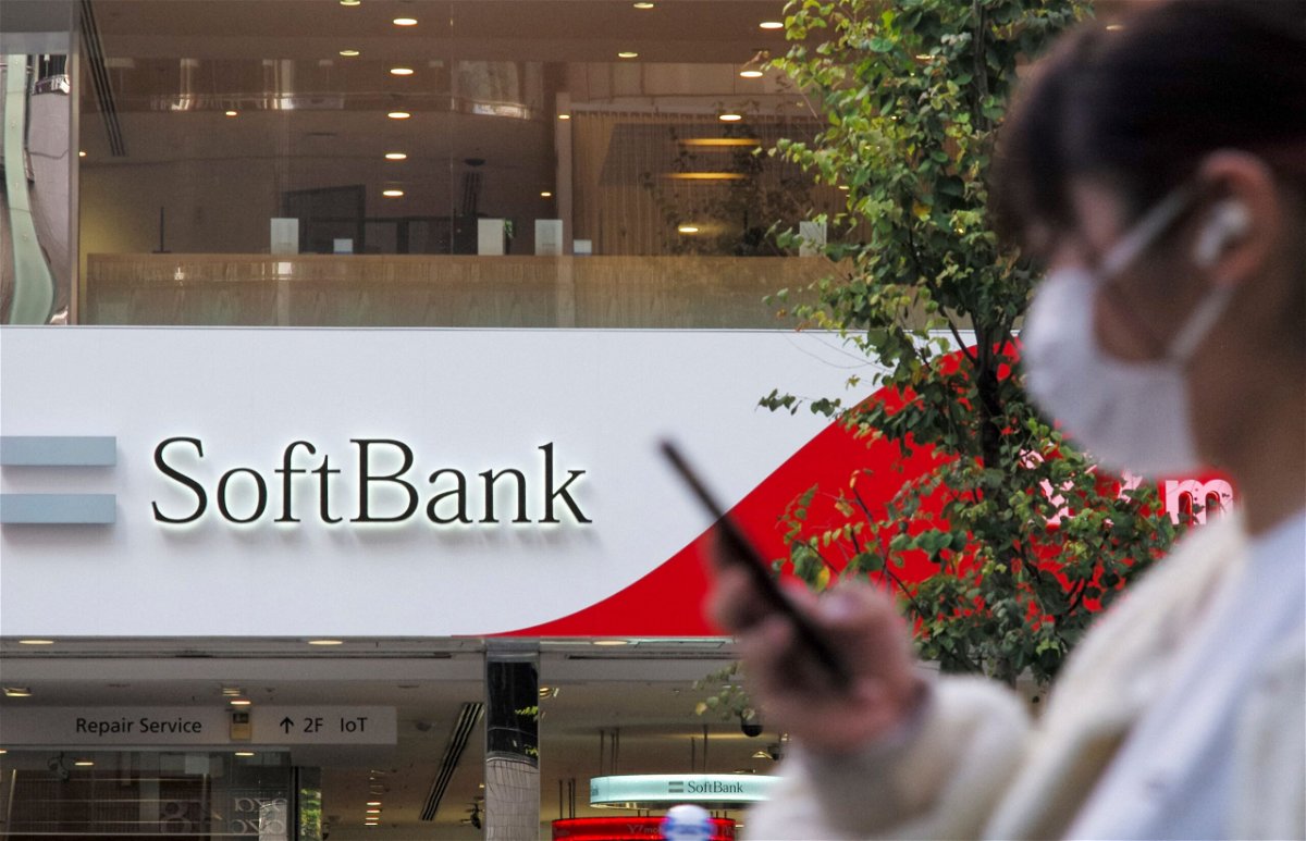 <i>Kazuhiro Nogi/AFP/Getty Images</i><br/>SoftBank hit by a report that China may force Didi to quit Wall Street. A woman here walks past a SoftBank mobile shop in Tokyo on November 8.