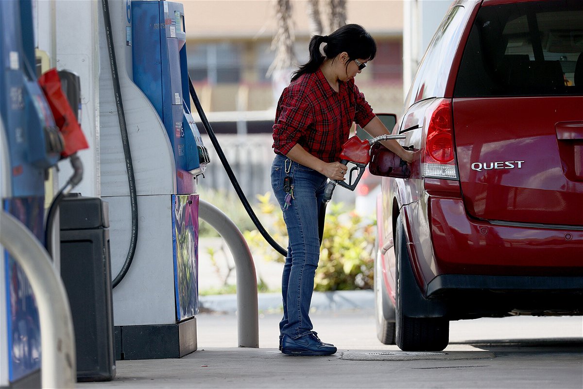 <i>Joe Raedle/Getty Images</i><br/>A customer pumps gas into her vehicle at a gas station on November 22