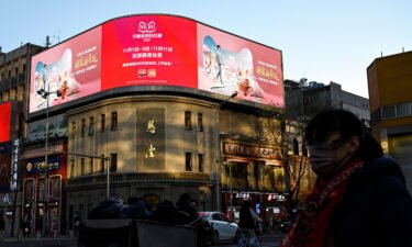 People walk past a billboard promoting the annual "Singles Day" on November 11