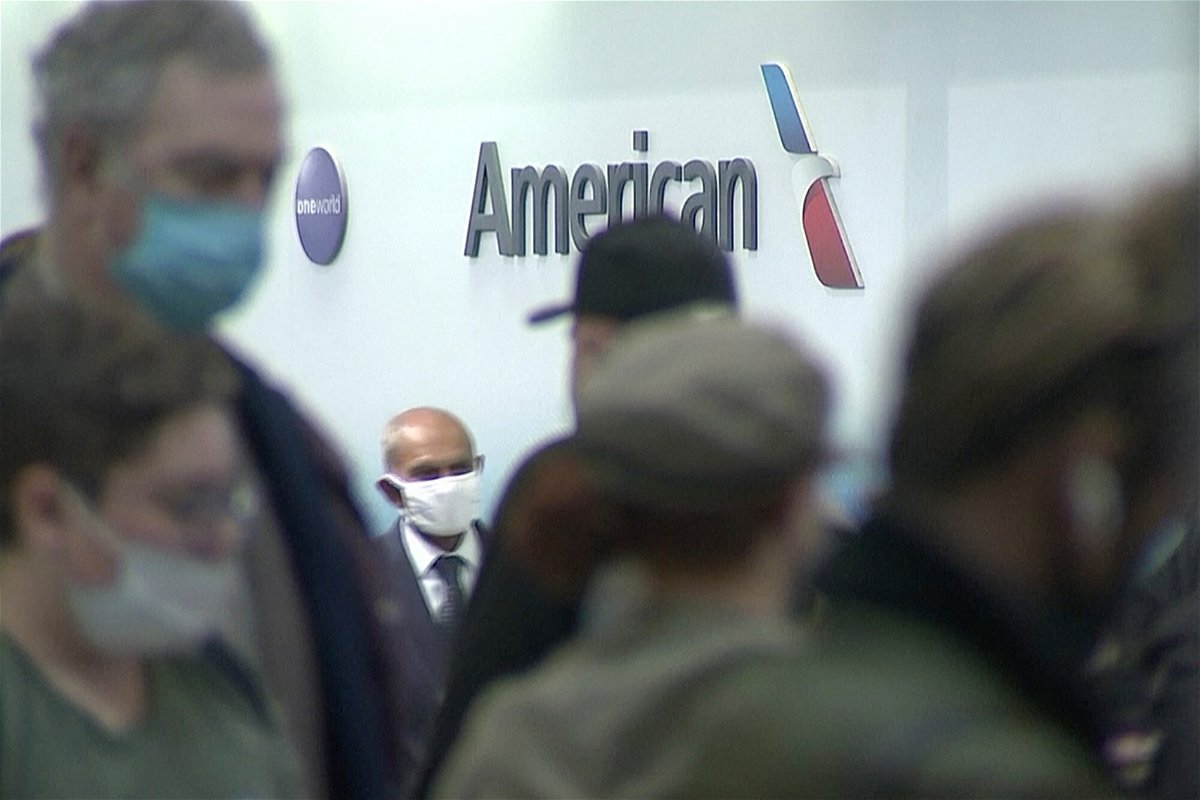 <i>WSOC-TV/AP</i><br/>People wait in line at an American Airlines counter at an airport in Charlotte