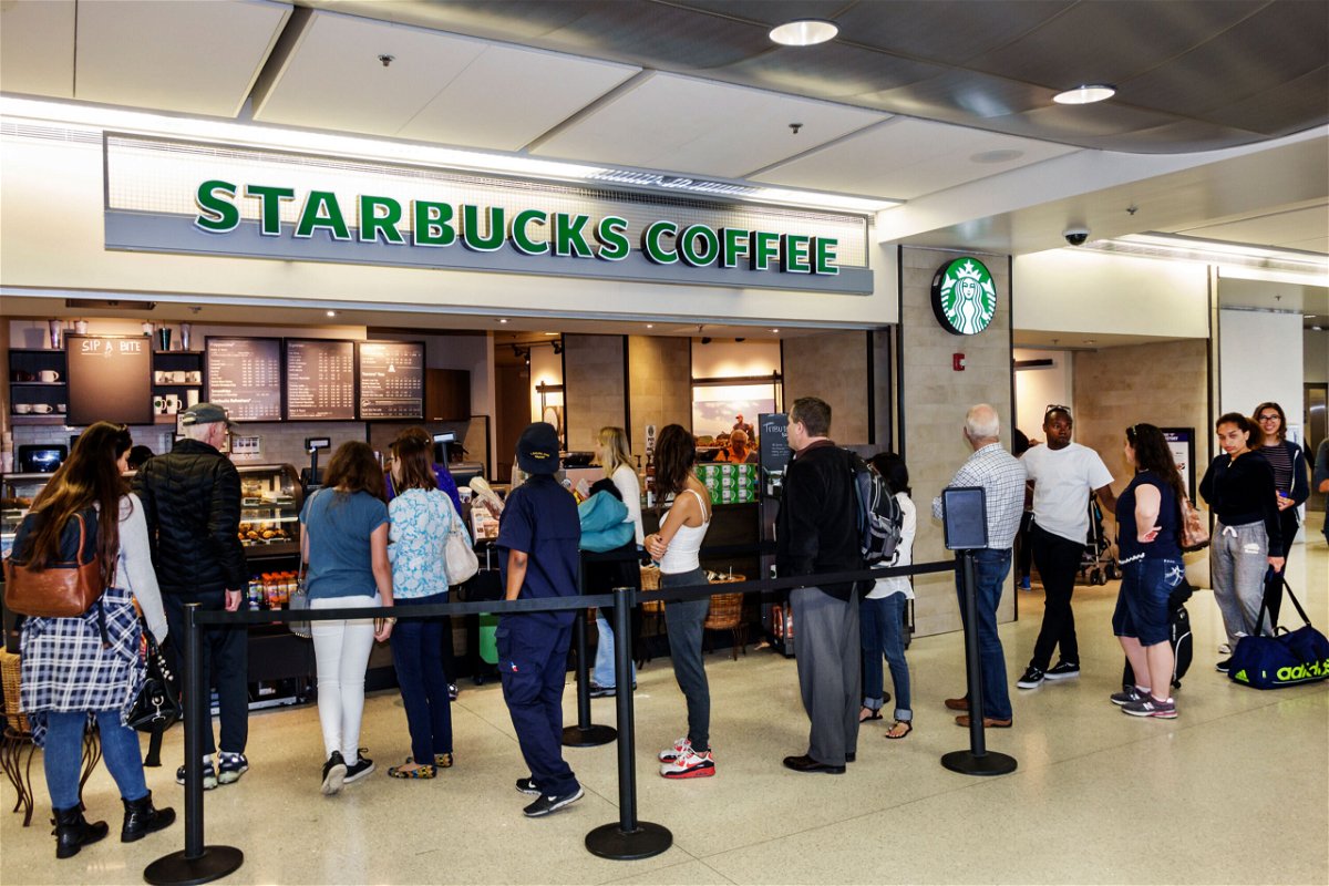 <i>Jeff Greenberg/Universal Images Group/Getty</i><br/>Customers wait in line at a Starbucks.