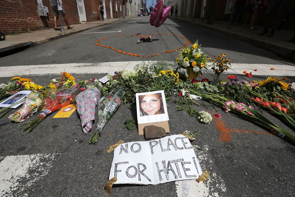 Flowers surround a photo of 32-year-old Heather Heyer, who was killed when a car plowed into a crowd of people protesting against the white supremacist Unite the Right rally, August 13, 2017 in Charlottesville, Virginia.