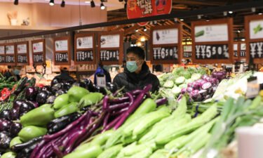 People buy vegetables at a supermarket at Congtai District on November 10