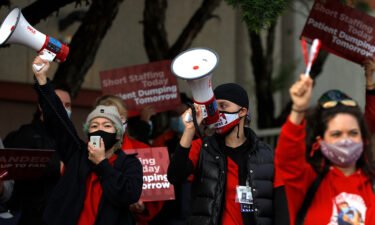 Kaiser Permanente nurses hold signs and use bullhorns during an informational picket outside of the Kaiser Permanente San Francisco Medical Center on November 10.