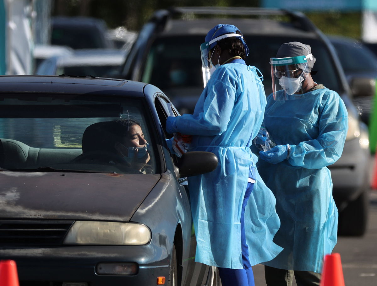 <i>Joe Raedle/Getty Images North America/Getty Images</i><br/>Healthcare workers conduct tests at a drive-thru COVID-19 testing site at the Dan Paul Plaza on December 29