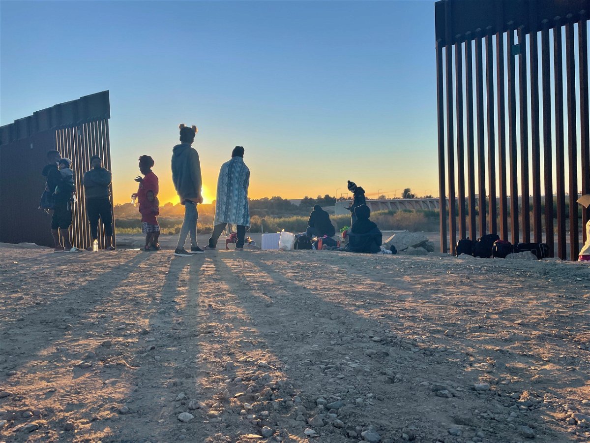 Migrants along a gap in the border wall in Yuma, Arizona.