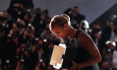 French director Julia Ducournau looks at her Palme d'Or for "Titane" at the closing ceremony of the 74th edition of the Cannes Film Festival in Cannes
