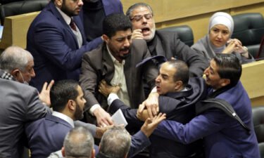 Jordanian parliament members are separated during an altercation in the parliament in the capital Amman on December 28.