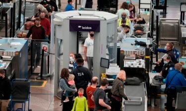 Christmas Eve air travel is well below 2019 levels amid flight cancellations as Omicron cases surge. Pictured are travelers at the Denver International Airport Friday