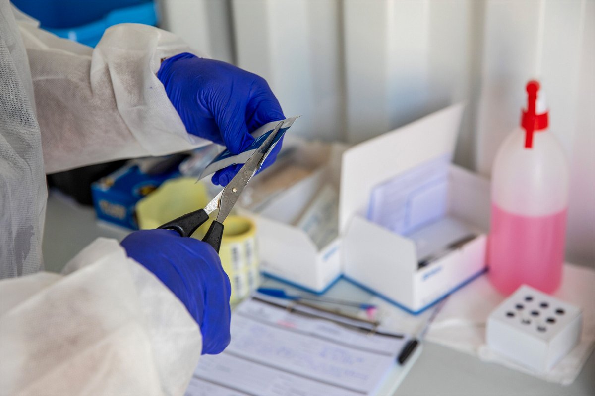 <i>Dwayne Senior/Bloomberg/Getty Images</i><br/>A health worker opens packaging for testing material at a Testaro Covid-19 mobile testing site outside Richmond Corner shopping centre in the Milnerton district of Cape Town