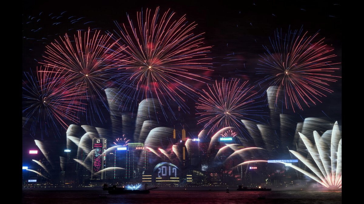 <i>DALE DE LA REY/AFP/Getty Images</i><br/>Fireworks explode over Victoria Harbor during New Year celebrations in Hong Kong on January 1