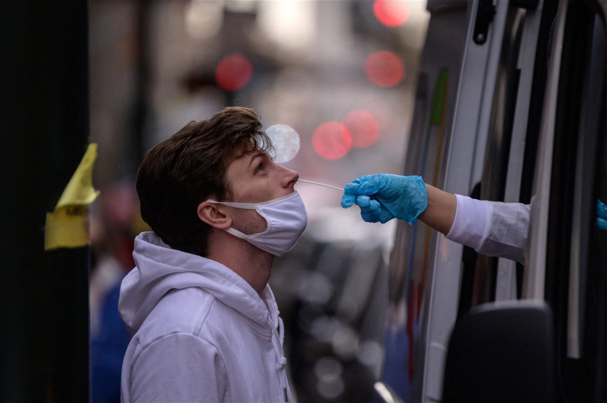 <i>Ed Jones/AFP/Getty Images</i><br/>A man receives a nasal swab during a test for Covid-19 at a street-side testing booth in New York on December 17.