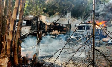 Smoke and flames rise from burnt out vehicles in Hpruso township