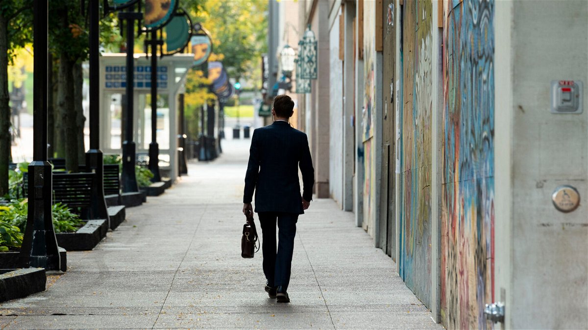 <i>Lauren Justice/Bloomberg/Getty Images</i><br/>HR executives share some of the biggest challenges of 2021. A person is seen carrying a briefcase while walking along State Street in Madison