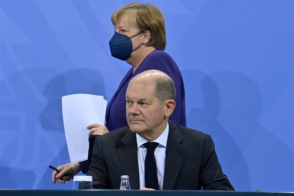 <i>John Macdougall/Picture-Alliance/DPA/AP</i><br/>Acting Chancellor Angela Merkel and Olaf Scholz hold a press conference on Covid-19 restrictions