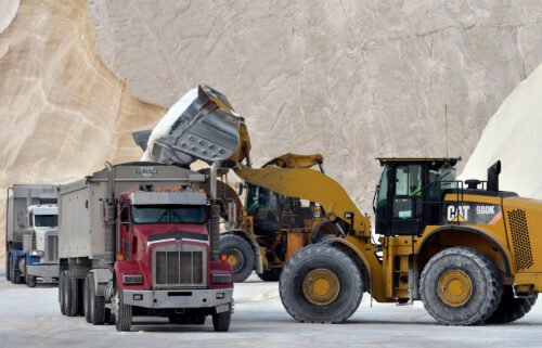 A bulldozer loads trucks with salt at Eastern Salt in Chelsea