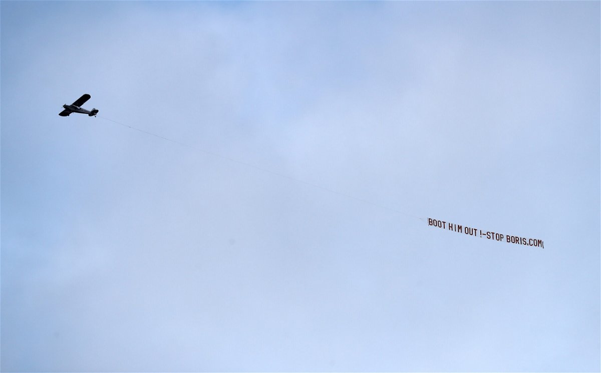 <i>George Wood/Getty Images</i><br/>A plane flies over the stadium with a message directed to UK Prime Minister Boris Johnson during the Premier League match between Leeds United and Newcastle United at Elland Road.