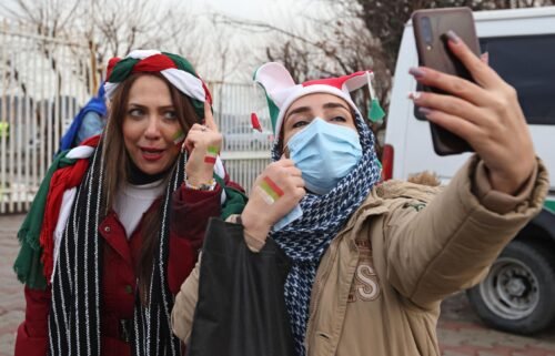 Iranian fans pose for a selfie ahead of the 2022 Qatar World Cup Asian Qualifiers match between Iran and Iraq.