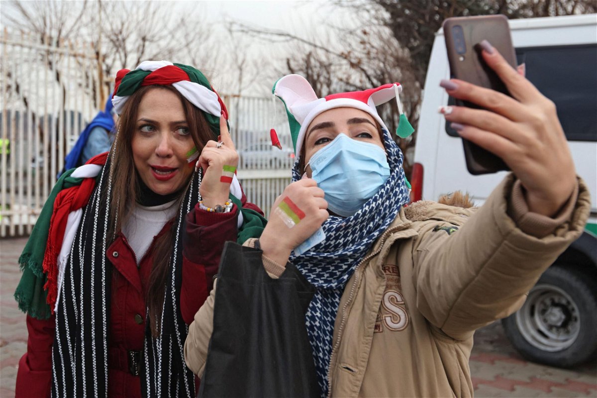 <i>Atta Kenare/AFP/Getty Images</i><br/>Iranian fans pose for a selfie ahead of the 2022 Qatar World Cup Asian Qualifiers match between Iran and Iraq.