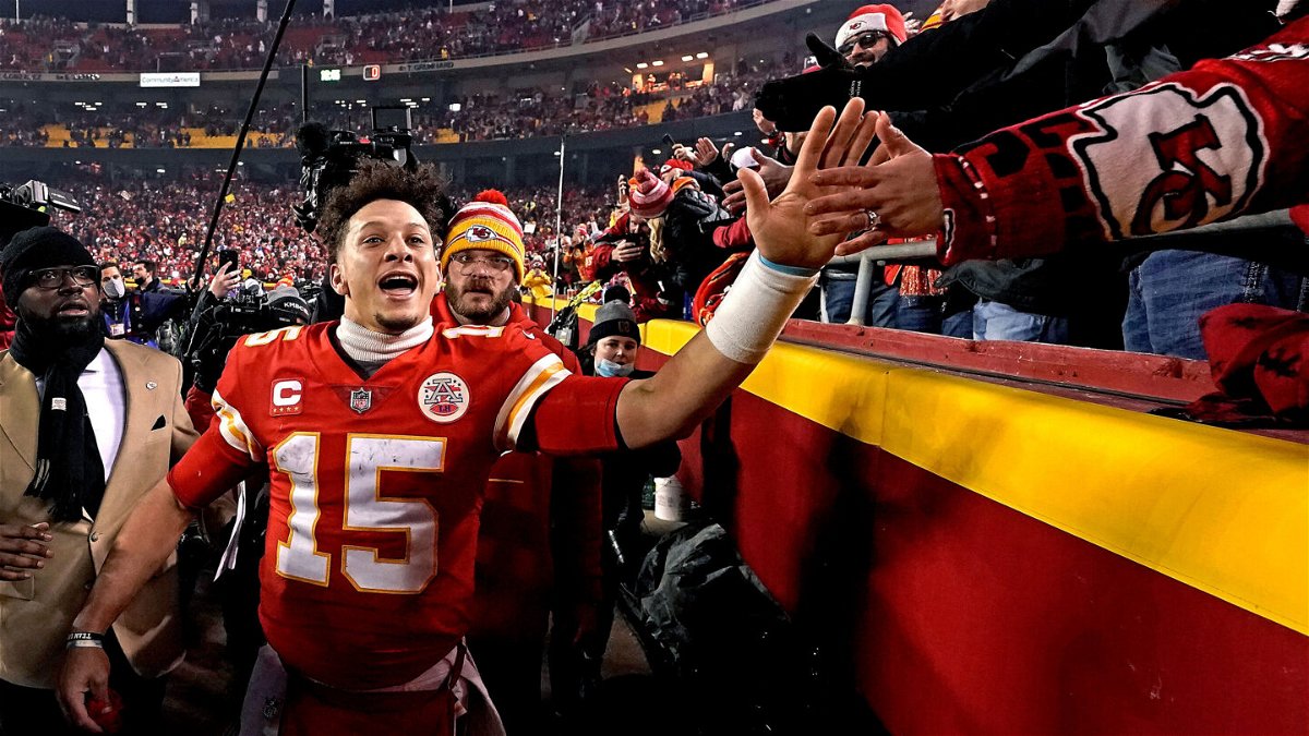 <i>Charlie Riedel/AP</i><br/>Chiefs QB Patrick Mahomes celebrates with fans after Kansas City's dramatic OT win against the Buffalo Bills.