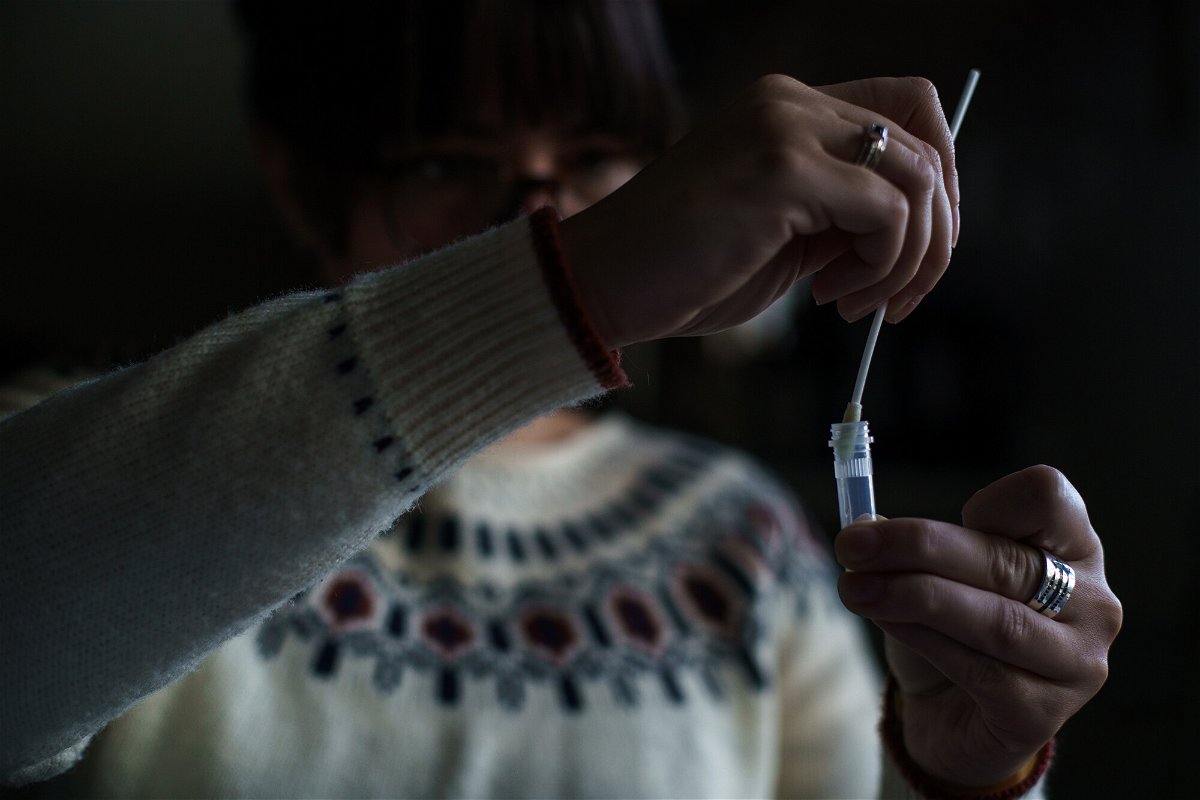 <i>John Tully/Bloomberg/Getty Images</i><br/>A resident processes a self-administered at-home Covid-19 test
