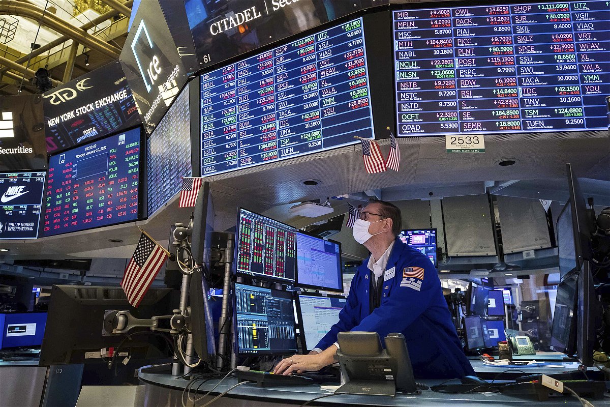 <i>Courtney Crow/New York Stock Exchange/AP</i><br/>Specialist Patrick King works on the floor of the New York Stock Exchange