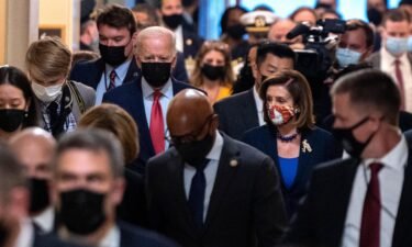 President Joe Biden flanked by Speaker of the House Nancy Pelosi are seen in October in Washington