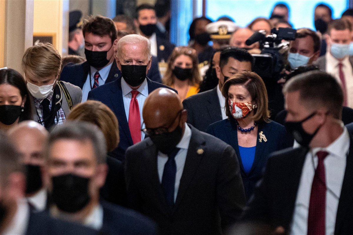 <i>ANDREW CABALLERO-REYNOLDS/AFP/Getty Images</i><br/>President Joe Biden flanked by Speaker of the House Nancy Pelosi are seen in October in Washington