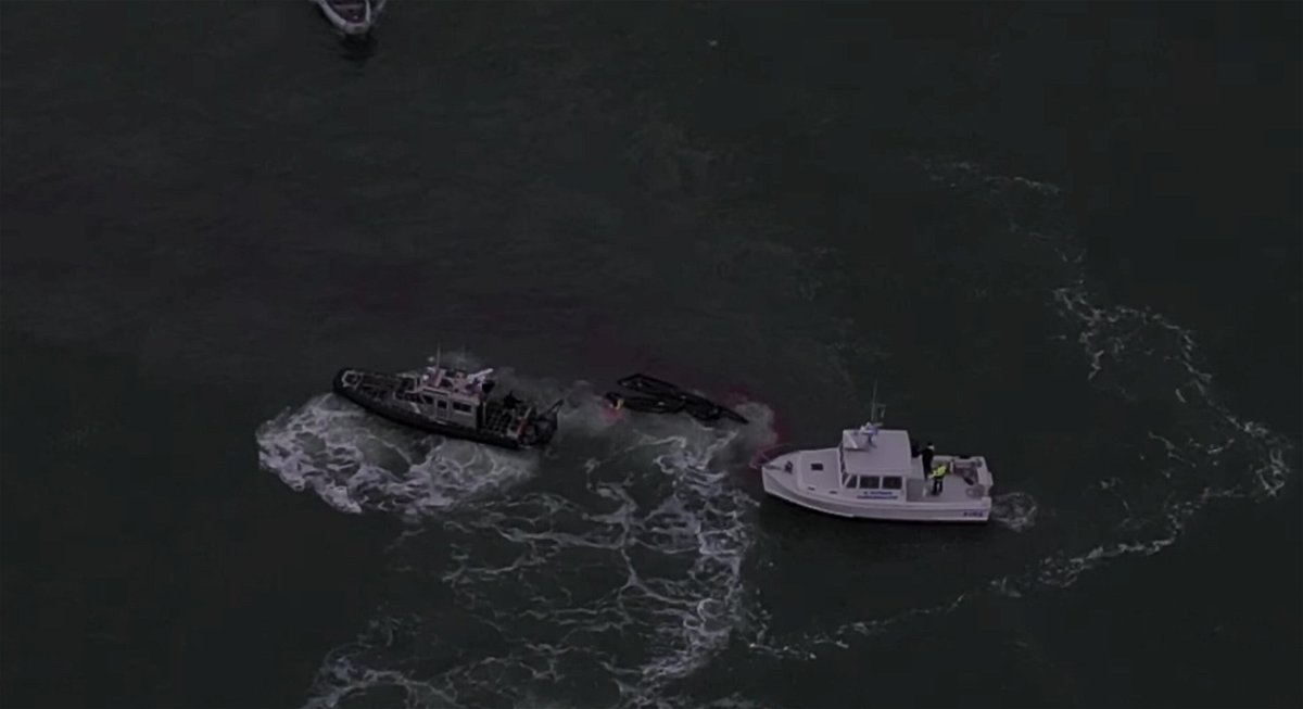 <i>Lieutenant Eric Norlin/SFD</i><br/>Rescuers work to save three fishermen who held on to debris surrounded by a slick of diesel fuel after their 55-foot boat sank on Tuesday.