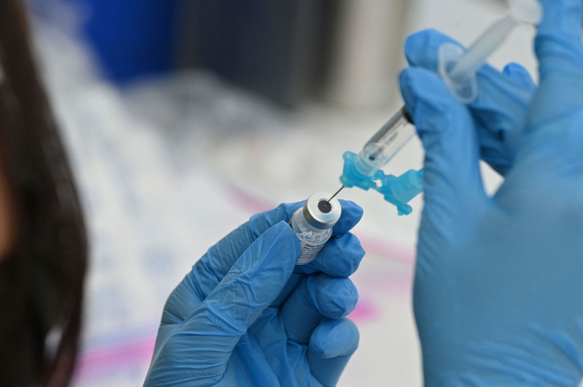 <i>ROBYN BECK/AFP/Getty Images</i><br/>A healthcare worker fills a syringe with Pfizer Covid-19 vaccine at a community vaccination event in a predominately Latino neighborhood in Los Angeles in 2021.