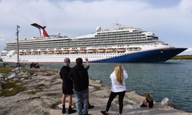 People watch as the Carnival Liberty cruise ship departs from Port Canaveral. Carnival Cruises will be relaxing its mask rules. A release from the company indicated masks will be recommended but not required on board from sailings departing on and after March 1.