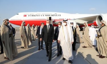 Turkish President Recep Tayyip Erdogan (L) is welcomed by Emirati officials after arriving at Abu Dhabi's international airport Monday.