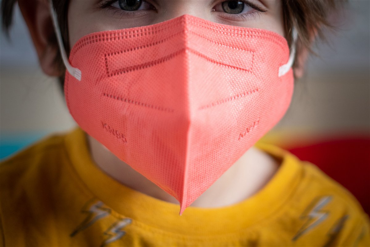 <i>Tiffany Hagler-Geard/Bloomberg/Getty Images</i><br/>A child wears a KN95 protective mask for kids on January 13 in New York.