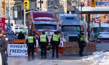 Canadian protesters block access to the busiest international crossing in North America as demonstrations against Covid-19 measures continue.
