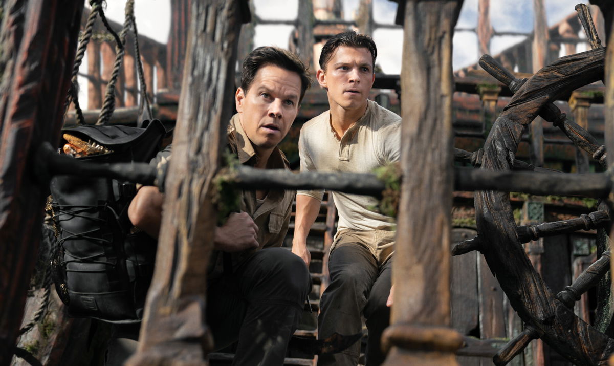 <i>Clay Enos/Columbia Pictures</i><br/>Mark Wahlberg and Tom Holland in 'Uncharted' (photo: Clay Enos).