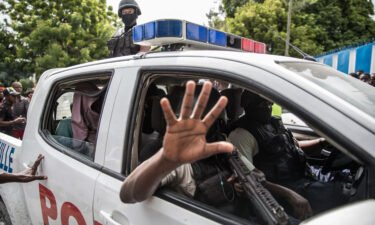 Haitian police transport two alleged suspects to a Port-au-Prince police station on July 8.