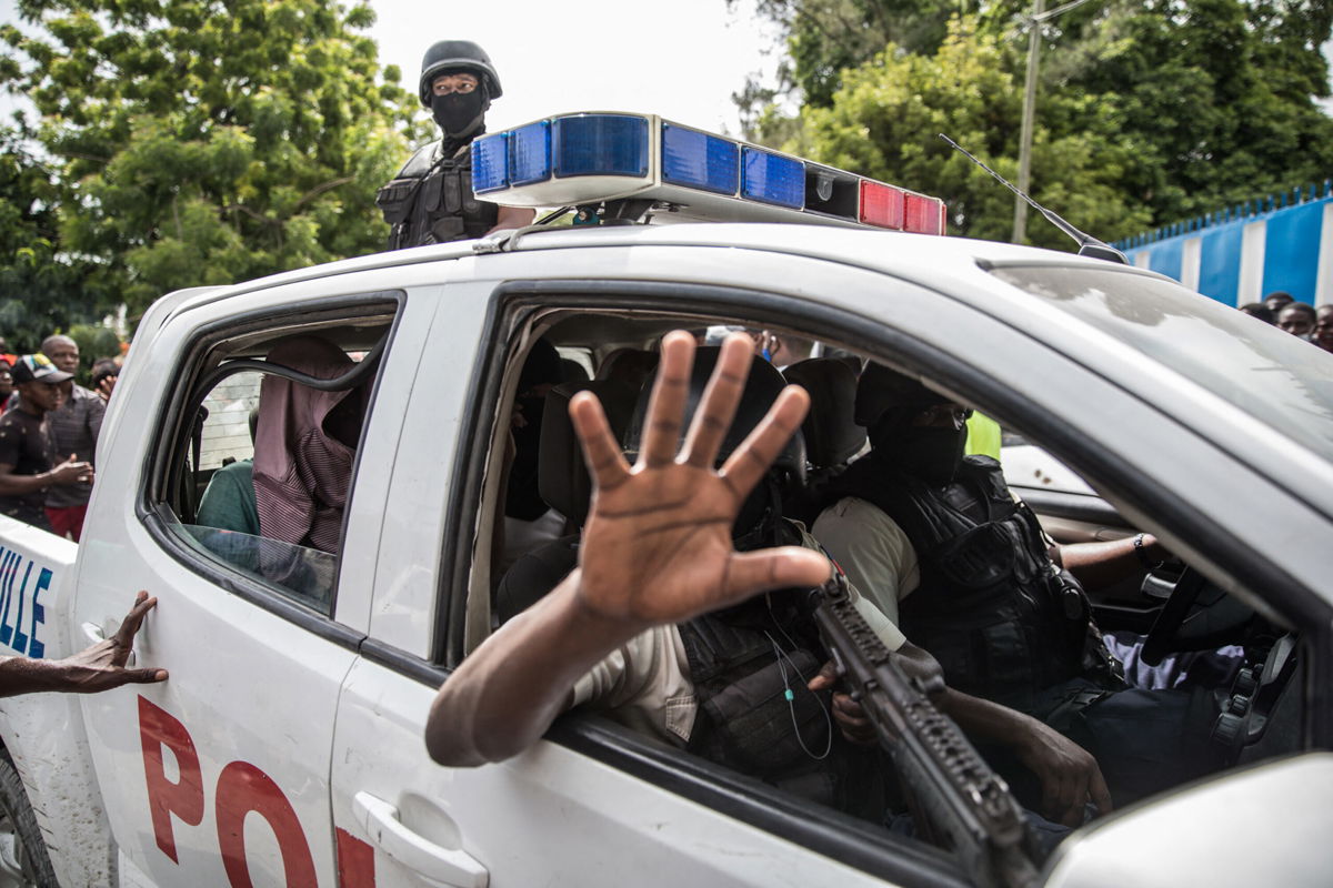 <i>Valerie Baeriswyl/AFP/Getty Images</i><br/>Haitian police transport two alleged suspects to a Port-au-Prince police station on July 8.