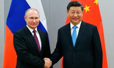 Russian President Vladimir Putin and China's President Xi Jinping shake hands at the BRICS Summit in Brazil in November