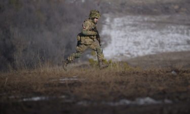 A Ukrainian serviceman runs during an exercise in the Joint Forces Operation