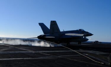 To land on the USS Harry S Truman