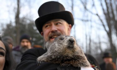 Groundhog Club handler A.J. Dereume holds Punxsutawney Phil on Wednesday.