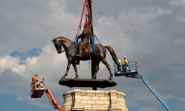 A statue of Confederate Gen. Robert E. Lee is removed from its pedestal on Monument Avenue on September 8